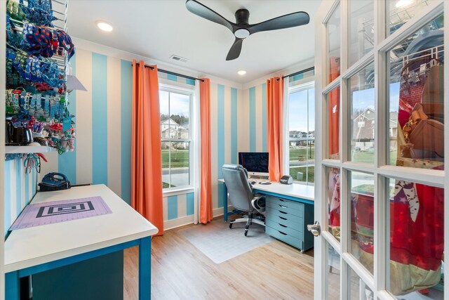 home office with visible vents, a ceiling fan, wallpapered walls, light wood finished floors, and baseboards