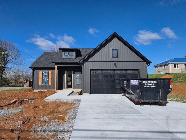 modern farmhouse style home with driveway, a garage, and roof with shingles