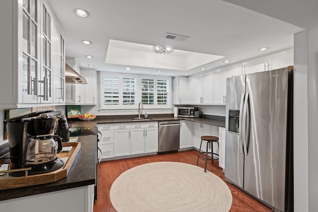 401 Bowling Ave Unit 31, Nashville, TN 37205 - kitchen with a sink, a tray ceiling, appliances with stainless steel finishes, and white cabinetry