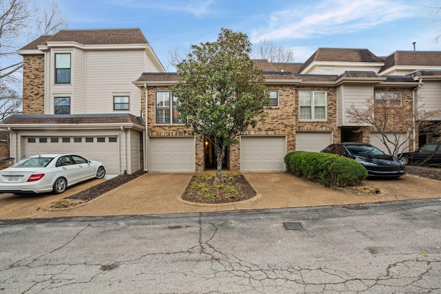 401 Bowling Ave Unit 31, Nashville, TN 37205 - view of property with brick siding, a garage, and driveway