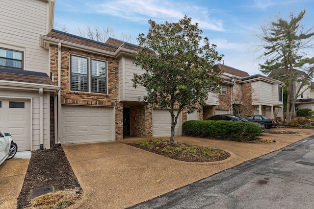 401 Bowling Ave Unit 31, Nashville, TN 37205 - multi unit property featuring a garage, brick siding, driveway, and a shingled roof