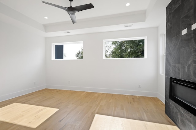 1815 14th Ave N Unit B, Nashville, TN 37208 - unfurnished living room featuring baseboards, light wood-style flooring, and a tray ceiling