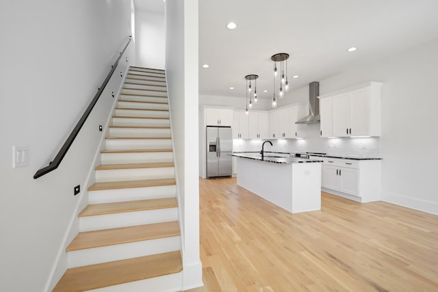 1815 14th Ave N Unit B, Nashville, TN 37208 - kitchen with decorative backsplash, light wood-style floors, stainless steel fridge with ice dispenser, wall chimney range hood, and a sink