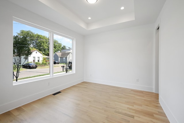 1815 14th Ave N Unit B, Nashville, TN 37208 - unfurnished room featuring baseboards, visible vents, a raised ceiling, and light wood-style floors