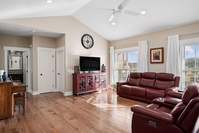 living area featuring ceiling fan, light wood-style floors, and a healthy amount of sunlight