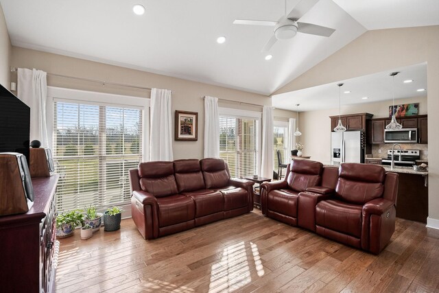 living room with recessed lighting, a ceiling fan, lofted ceiling, and hardwood / wood-style flooring