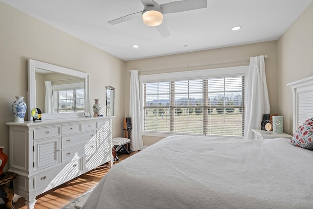 bedroom with recessed lighting, multiple windows, a ceiling fan, and wood finished floors