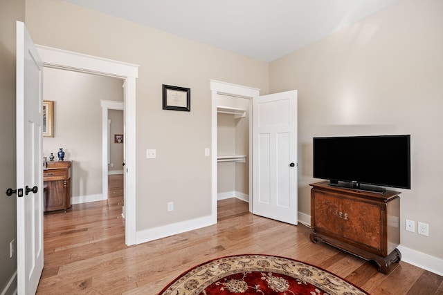 bedroom featuring light wood-style flooring and baseboards