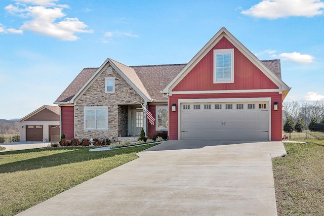 craftsman inspired home featuring roof with shingles, a front yard, stone siding, a garage, and concrete driveway