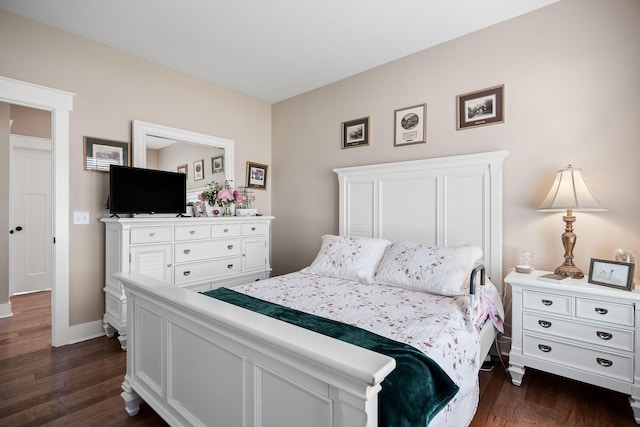 bedroom with baseboards and dark wood finished floors