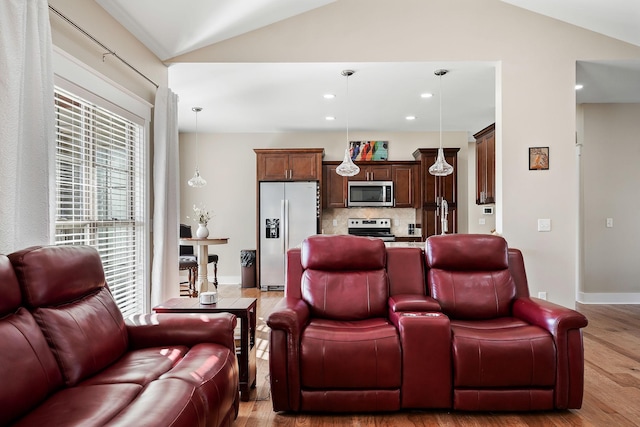 living room featuring light wood-type flooring, baseboards, vaulted ceiling, and recessed lighting