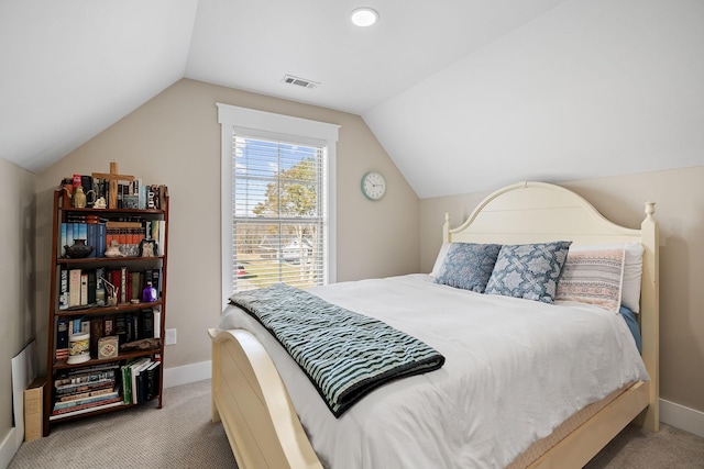 carpeted bedroom with visible vents, baseboards, and lofted ceiling