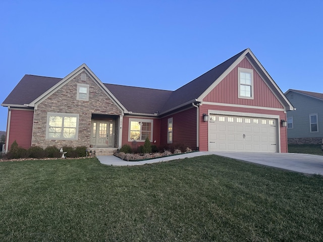 view of front of home with concrete driveway, an attached garage, stone siding, and a front lawn