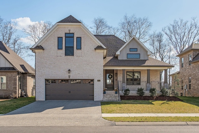 1024 Jackston Mack Way, Gallatin, TN 37066 - view of front of home with brick siding, a porch, concrete driveway, and a front lawn