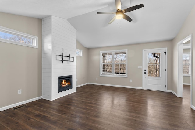 530 S Oak St, Hohenwald, TN 38462 - unfurnished living room with a large fireplace, baseboards, dark wood finished floors, visible vents, and lofted ceiling