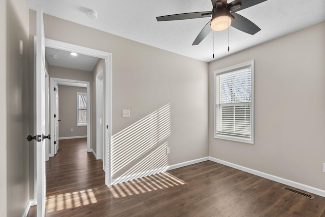 530 S Oak St, Hohenwald, TN 38462 - empty room with visible vents, baseboards, ceiling fan, and wood finished floors