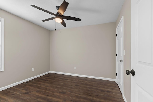 530 S Oak St, Hohenwald, TN 38462 - spare room with baseboards, visible vents, dark wood-style flooring, and a ceiling fan