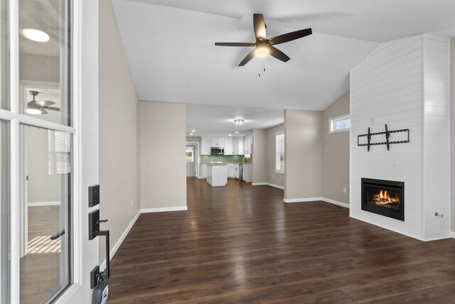 530 S Oak St, Hohenwald, TN 38462 - unfurnished living room with a fireplace, a ceiling fan, vaulted ceiling, and dark wood-style floors