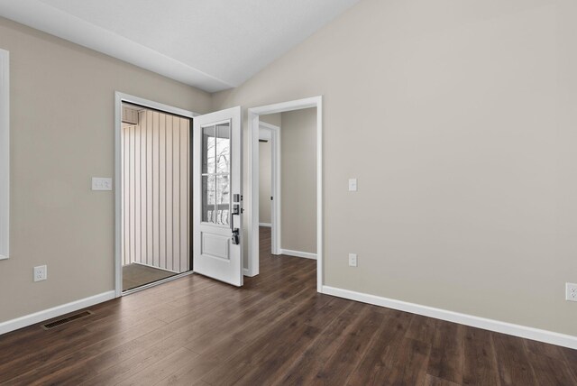 530 S Oak St, Hohenwald, TN 38462 - interior space with visible vents, baseboards, vaulted ceiling, and dark wood-style floors