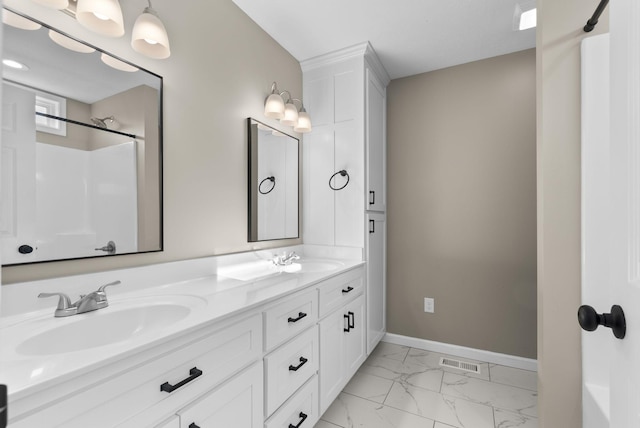 530 S Oak St, Hohenwald, TN 38462 - bathroom with baseboards, double vanity, visible vents, marble finish floor, and a sink