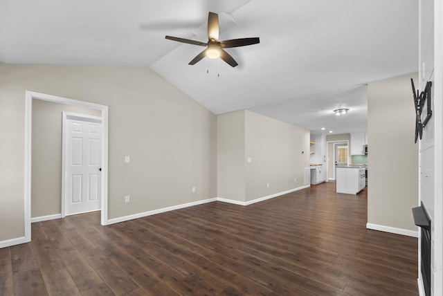 530 S Oak St, Hohenwald, TN 38462 - unfurnished living room featuring baseboards, a ceiling fan, vaulted ceiling, and dark wood-style floors