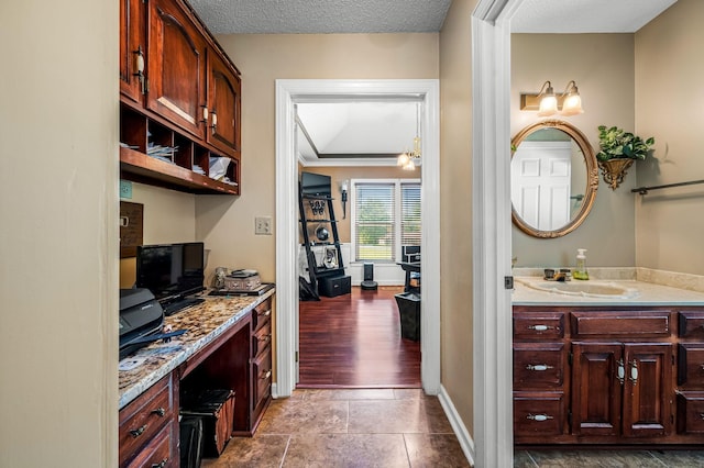 1712 Lake Grassland W, Gallatin, TN 37066 - interior space featuring a sink, baseboards, light stone countertops, and a textured ceiling