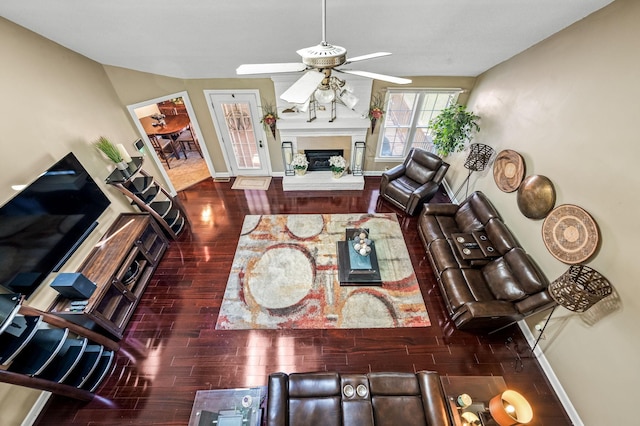 1712 Lake Grassland W, Gallatin, TN 37066 - living area featuring wood finished floors, a ceiling fan, baseboards, and a fireplace with raised hearth