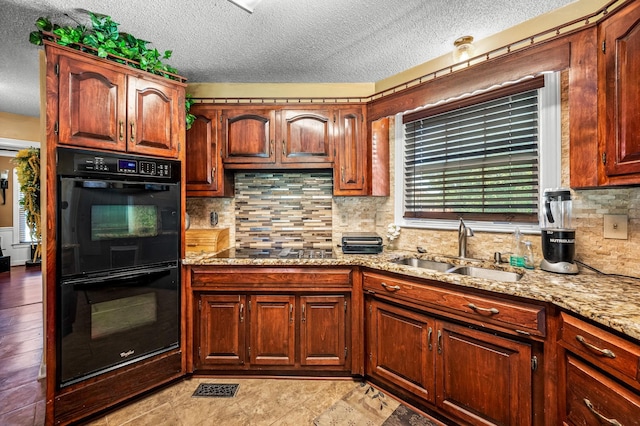 1712 Lake Grassland W, Gallatin, TN 37066 - kitchen featuring light stone counters, a sink, black appliances, a textured ceiling, and backsplash