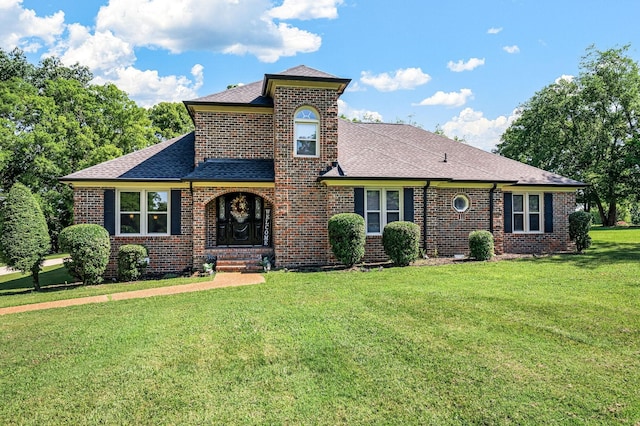 1712 Lake Grassland W, Gallatin, TN 37066 - view of front facade featuring brick siding, a front yard, and a shingled roof