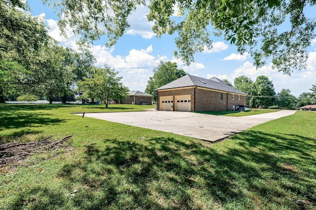 1712 Lake Grassland W, Gallatin, TN 37066 - view of side of home featuring brick siding, a lawn, driveway, and an attached garage