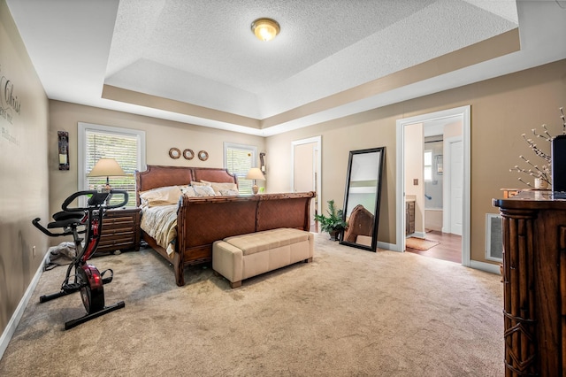 1712 Lake Grassland W, Gallatin, TN 37066 - carpeted bedroom with a raised ceiling, baseboards, ensuite bathroom, and a textured ceiling