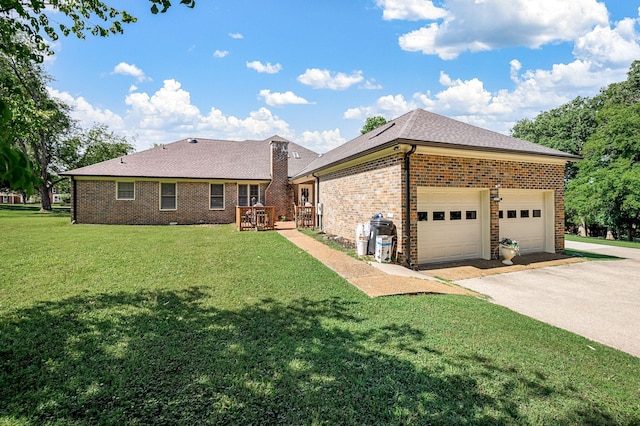 1712 Lake Grassland W, Gallatin, TN 37066 - exterior space featuring a lawn, driveway, an attached garage, a shingled roof, and brick siding