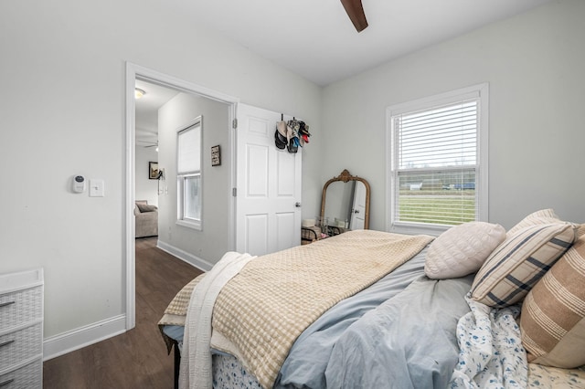 bedroom featuring a ceiling fan, wood finished floors, and baseboards