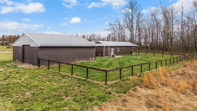 view of yard with an outbuilding and fence