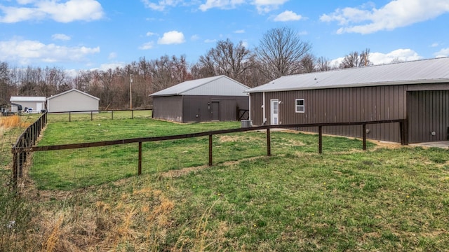 view of yard with an outbuilding and fence
