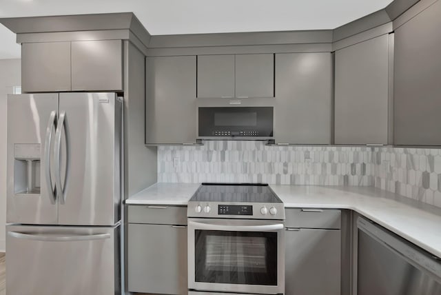 1815 Martin St Unit A, Nashville, TN 37203 - kitchen with appliances with stainless steel finishes, gray cabinets, light countertops, backsplash, and modern cabinets