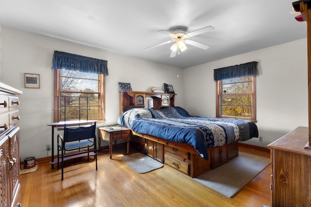 bedroom with wood finished floors, baseboards, and ceiling fan