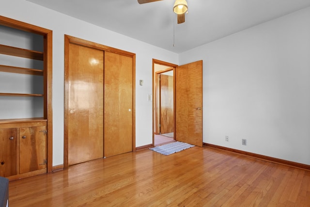 unfurnished bedroom with baseboards, light wood-style flooring, and a ceiling fan