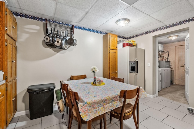 4897 Sulphur Creek Rd, Nashville, TN 37218 - dining room featuring baseboards, washing machine and dryer, a drop ceiling, and light tile patterned floors