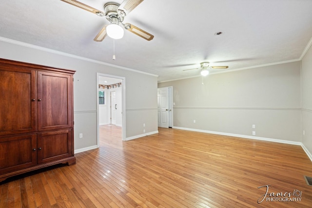 interior space featuring baseboards, light wood-style flooring, a ceiling fan, and crown molding