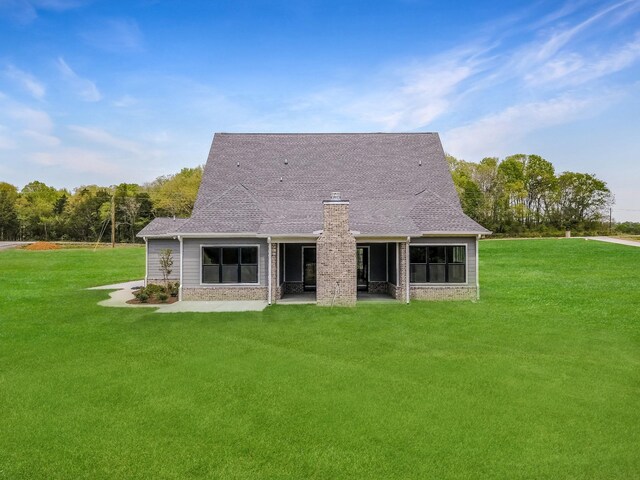 7004 Twelve Corners Rd, Lascassas, TN 37085 - rear view of property featuring a chimney, a lawn, a patio area, and a shingled roof
