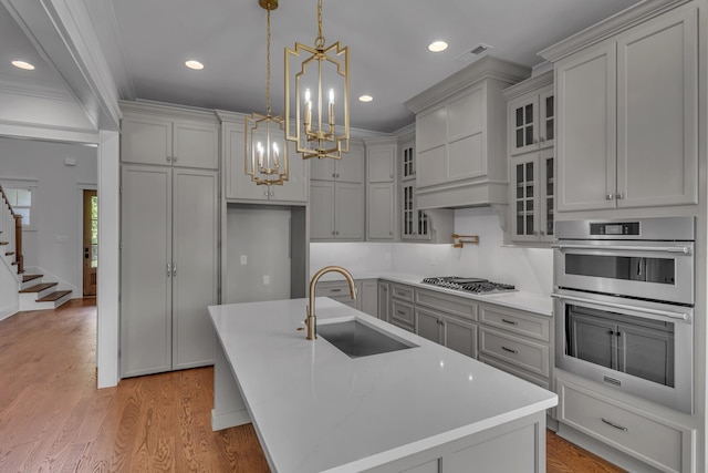 7004 Twelve Corners Rd, Lascassas, TN 37085 - kitchen with a sink, stainless steel appliances, a chandelier, light wood-style floors, and light countertops