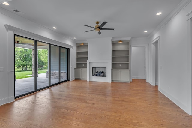 7004 Twelve Corners Rd, Lascassas, TN 37085 - unfurnished living room featuring ornamental molding, a ceiling fan, light wood-type flooring, built in features, and baseboards