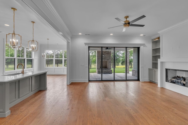 7004 Twelve Corners Rd, Lascassas, TN 37085 - unfurnished living room with a ceiling fan, a fireplace, crown molding, built in features, and a sink
