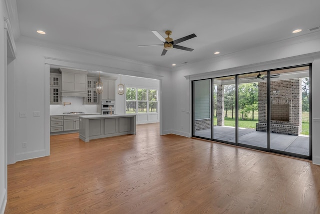 7004 Twelve Corners Rd, Lascassas, TN 37085 - unfurnished living room with ceiling fan, baseboards, light wood-type flooring, crown molding, and recessed lighting
