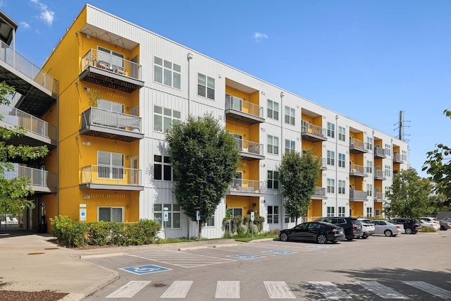 view of building exterior featuring uncovered parking
