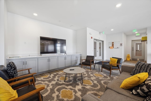 living area with recessed lighting and wood finished floors