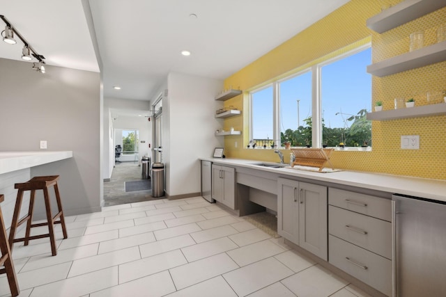 bathroom featuring tasteful backsplash, vanity, track lighting, baseboards, and recessed lighting