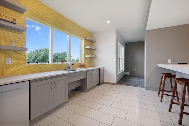 kitchen with open shelves, dishwasher, tasteful backsplash, and gray cabinets