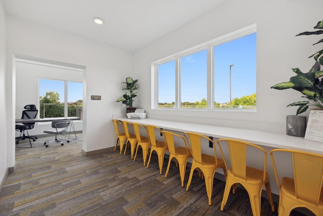 dining area featuring recessed lighting, dark colored carpet, and baseboards